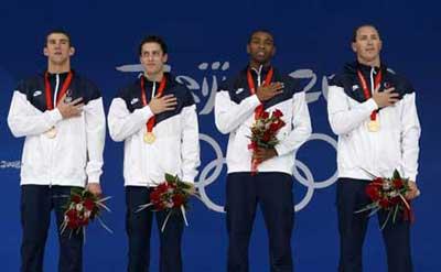 U.S. swimmers Michael Phelps，Weber-Gale，Cullen Jones and Jason Lezak (L to R) listen to their national anthem during the awarding ceremony of men's 4X100m freestyle relay at the Beijing 2008 Olympic Games in the National Aquatics Center, also known as the Water Cube in Beijing, China, Aug. 11, 2008. The United States set a new world record and won the gold medal in the event with 3 minutes 8.24 seconds. (Xinhua/Fei Maohua)