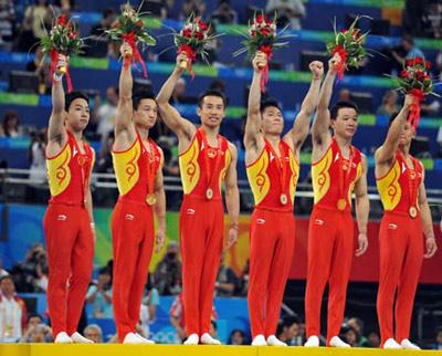 China's Zou Kai, Yang Wei, Xiao Qin, Li Xiaopeng, Huang Xu and Chen Yibing (L-R) wave to spectators on the podium during the awarding ceremony for gymnastics artistic men's team competition of the Beijing 2008 Olympic Games at National Indoor Stadium in Beijing, China, Aug. 12, 2008. The Chinese team won the gold medal of the event with 286.125 points. (Xinhua/Wang Lei)