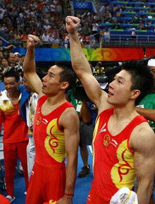 China's Li Xiaopeng (R) and Xiao Qin jubilate after gymnastics artistic men's team final of the Beijing 2008 Olympic Games at National Indoor Stadium in Beijing, China, Aug. 12, 2008. The Chinese team claimed the title of the event with 286.125 points. (Xinhua/Ren Long)