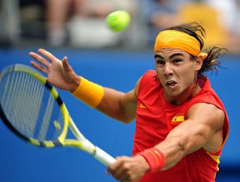 Rafael Nadal of Spain returns a hit against Potito Starace of Italy in the first round of the men's singles of the Olympic tennis competition in Beijing, China, Aug. 11, 2008. Nadal beat Starace 2-1.(Xinhua/Wang Yuguo)