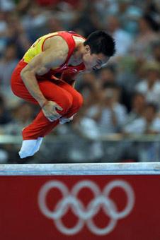 China's Yang Wei performs the parallel bars during gymnastics artistic men's team final of the Beijing 2008 Olympic Games at National Indoor Stadium in Beijing, China, Aug. 12, 2008. The Chinese team won the gold medal of the event with 286.125 points.(Xinhua Photo)