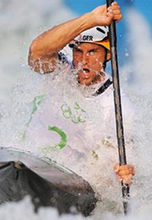 Alexander Grimm of Germany paddles during the men's kayak(K1) final of Olympic canoe/kayak slalom competition, in the Shunyi Rowing-Canoeing Park in Beijing, China, Aug. 12, 2008. Grimm claimed the title in this event.(Xinhua Photo)