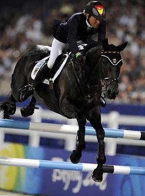 German rider Ingrid Klimke and horse Abraxxas jump during the eventing jumping competition of the Beijing 2008 Olympic Games equestrian events at Hong Kong Olympic Equestrian Venue (Sha Tin) in the Olympic co-host city of Hong Kong, south China, Aug. 12, 2008. Germany won the first Olympic Eventing Team gold medal in the three-day eventing here Tuesday night with a total penalty of 166.10. (Xinhua/Lui Siu Wai)