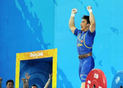 Liao Hui of China celebrates after taking a successful lift during the men's 69kg final of weightlifting at Beijing 2008 Olympic Games in Beijing, China, Aug. 12, 2008. Liao won the gold medal with a total of 348 kilos.(Xinhua Photo)