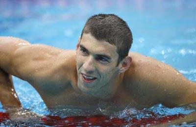 Michael Phelps of the United States smiles after winning the men's 200m butterfly final at the Beijing 2008 Olympic Games in the National Aquatics Center, also known as the Water Cube in Beijing, China, Aug. 13, 2008. Phelps set a new world record and won the gold medal in the event with 1 minute 52.03 seconds. (Xinhua/Ding Xu)