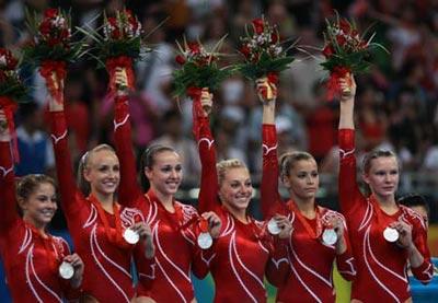 Girls of the United States celebrate during the awarding ceremony for gymnastics artistic women's team final of Beijing 2008 Olympic Games at National Indoor Stadium in Beijing, China, Aug. 13, 2008. The US team ranked the second with a score of 186.525. (Xinhua/Ren Long)