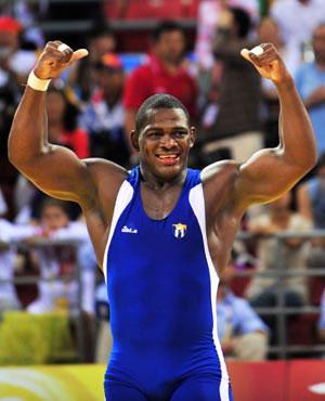 Mijain Lopez of Cuba celebrates after beating Khasan Baroev of Russia during the men’s Greco-Roman 120kg final at the Beijing 2008 Olympic Games wrestling event in Beijing, China, Aug. 14, 2008. Mijain Lopez won the bout and grabbed the gold medal.(Xinhua Photo)