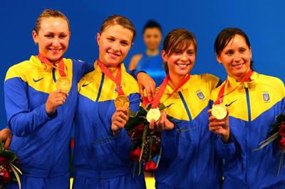 Ukraine team mates (L-R) Olha Zhovnir, Olga Kharlan, Halyna Pundyk and Olena Khomrova celebrate winning the gold medal. (Photo credit: Phil Walter/Getty Images)
