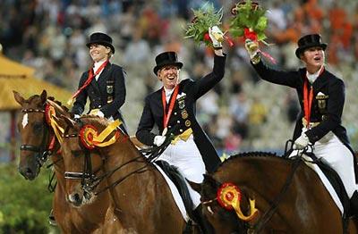The team of Germany celebrate after receiving gold medals of dressage team final of Beijing 2008 Olympic equestrian events in the Olympics co-host city of Hong Kong, south China, Aug. 14, 2008. Germany won the Olympic team dressage gold medal, their 7th successive Olympic title, in Hong Kong Thursday night. (Xinhua)