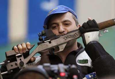 Artur Ayvazian of Ukraine kisses his rifle after winning the men's 50m rifle prone final of Shooting at Beijing 2008 Olympic Games in Beijing, China, Aug. 15, 2008. Artur Ayvazian claimed the gold with a total of 702.7. (Xinhua/Bao Feifei)