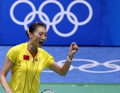 Zhang Ning of China celebrates for a point while competing against teammate Xie Xingfang at the women's singles gold medal match during the Beijing 2008 Olympic Games badminton event, in Beijing, China, Aug. 16, 2008. Zhang Ning won the match 2-1 and grabbed the gold medal of the event. (Xinhua/Zhang Chen)