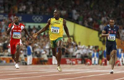 Usain Bolt of Jamaica (C) celebrates winning the men's 100m final of the athletics competition in the National Stadium at the Beijing 2008 Olympic Games August 16, 2008.