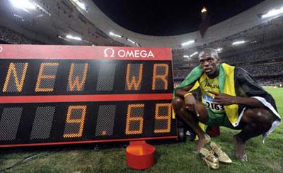 Usain Bolt of Jamaica points at his race time after winning the men's 100m final of the athletics competition in the National Stadium at the Beijing 2008 Olympic Games August 16, 2008. Bolt won 100 metres gold at the Beijing Olympics in a world record time on Saturday, running 9.69 seconds to claim victory in an exhilarating showdown with his compatriot Asafa Powell.