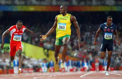 Usain Bolt of Jamaica (C) crosses the finish line ahead of Richard Thompson (L) of Trinidad and Tobago and Doc Patton of the US (R) to win the men's 100m final in the athletics competition at the National Stadium during the 2008 Beijing Olympic Games on August 16, 2008. Bolt won with a world record time of 9.69sec.