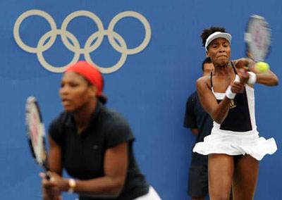 Serena Williams (L) and Venus Williams of the United States compete during the women's doubles gold medal match of Beijing Olympic Games tennis event against Virginia Ruano Pascual and Anabel Medina Garrigues of Spain in Beijing, China, Aug. 17, 2008. Serena Williams and Venus Williams won the match and grabbed gold medal in this event. (Xinhua/Zou Zheng)