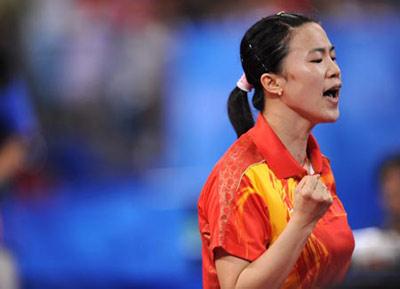 Wang Nan of China celebrates after defeating Feng Tianwei of Singapore during the women's team gold medal contest of Beijing Olympic Games table tennis event between China and Singapore in Beijing, China, Aug. 17, 2008. China beat Singapore 3-0 and claimed the title in this event. (Xinhua Photo)