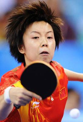 Zhang Yining of China returns the ball during the women's team gold medal contest of Beijing Olympic Games table tennis event between China and Singapore in Beijing, China, Aug. 17, 2008. China beat Singapore 3-0 and claimed the title in this event.(Xinhua Photo)