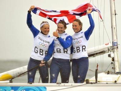Sarah Ayton, Sarah Webb, and Pippa Wilson of Great Britain celebrate after victory of the Yngling medal race at the Beijing 2008 Olympic Games sailing event at Qingdao Olympic Sailing Center in Qingdao, an-Olympic co-host city in eastern China’s Shandong Province, Aug. 17, 2008. The British team won the gold medal of the event.(Xinhua Photo)