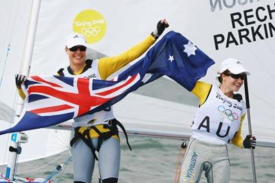 Elise Rechichi and Tessa Parkinson of Australia wave to spectators with the Australian national flag after the 470 Women Medal Race at the Beijing 2008 Olympic Games sailing event at Qingdao Olympic Sailing Center in Qingdao, an-Olympic co-host city in eastern China's Shandong Province, Aug. 18, 2008. Australian pair Elise Rechichi and Tessa Parkinson won the gold medal. (Xinhua Photo)