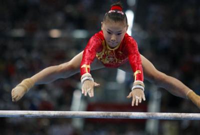 He Kexin of China performs on the uneven bars during women's uneven bars final of Beijing 2008 Olympic Games gymnastics artistic event at National Indoor Stadium in Beijing, China, Aug. 18, 2008. He Kexin claimed the title of the event with a score of 16.725. (Xinhua Photo)