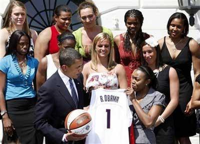 President Barack Obama poses for photos with the NCAA champion University of Connecticut women's basketball team in front of the South Portico of the White House in Washington, Monday, April 27, 2009.(AP Photo/Gerald Herbert) 