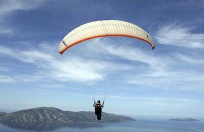 A paraglider flies over the city of Vlore during an annual Balkan competition, some 150 km (94 miles) from the capital Tirana, May 9, 2009. (Xinhua/Reuters Photo)