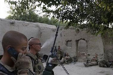 Bravo Company commander Cpt. Drew Schoenmaker of the U.S. Marines 2nd Marine Expeditionary Brigade, 1st Battalion 5th Marines gathers with his Marines in a abandoned farm house in the Nawa district in Afghanistan's Helmand province Friday July 3, 2009.AP Photo/David Guttenfelder)