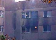 飛機墜毀現場的一棟居民樓冒出火焰